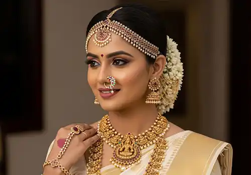 South Indian bridal makeup artist with traditional Kanjivaram look and jasmine floral hair styling