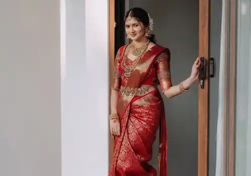 South Indian bridal wear designer with traditional Kanjeevaram silk saree and temple jewellery coordination