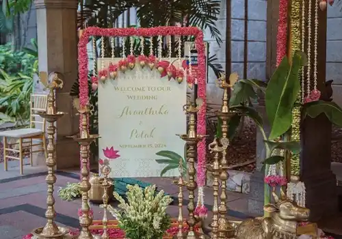 South Indian floral designer with traditional jasmine gajra and mango leaf garland arrangements